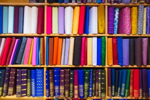 colorful fabrics displayed in shelves at store PEPFS6T